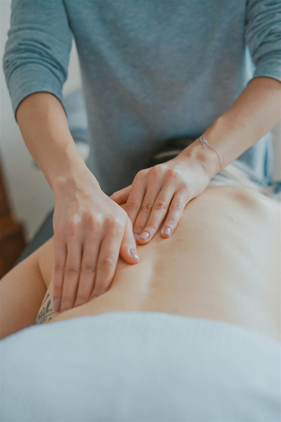 Colleen performing therapeutic massage on a client