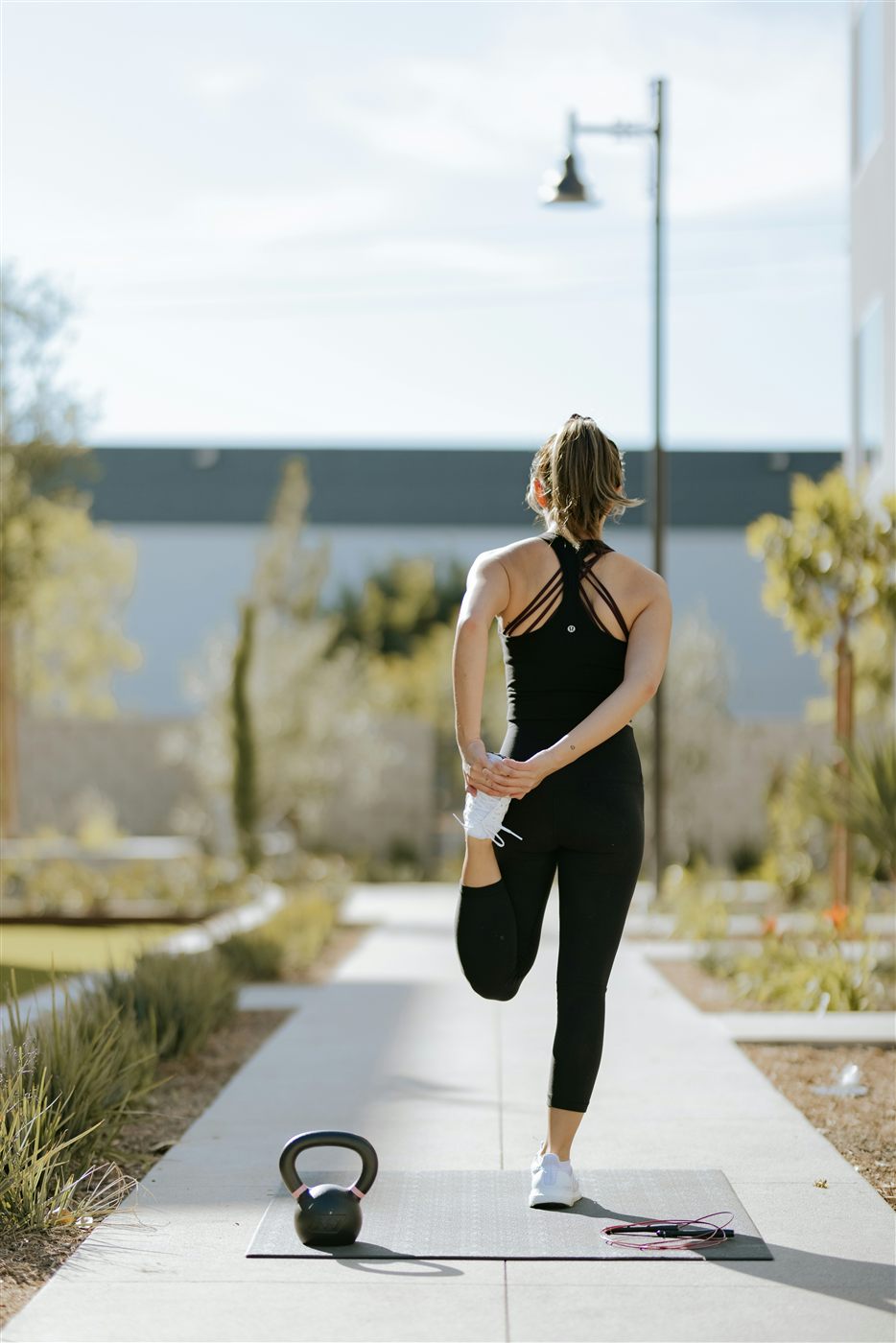 Outdoor training session with kettlebell and jump rope